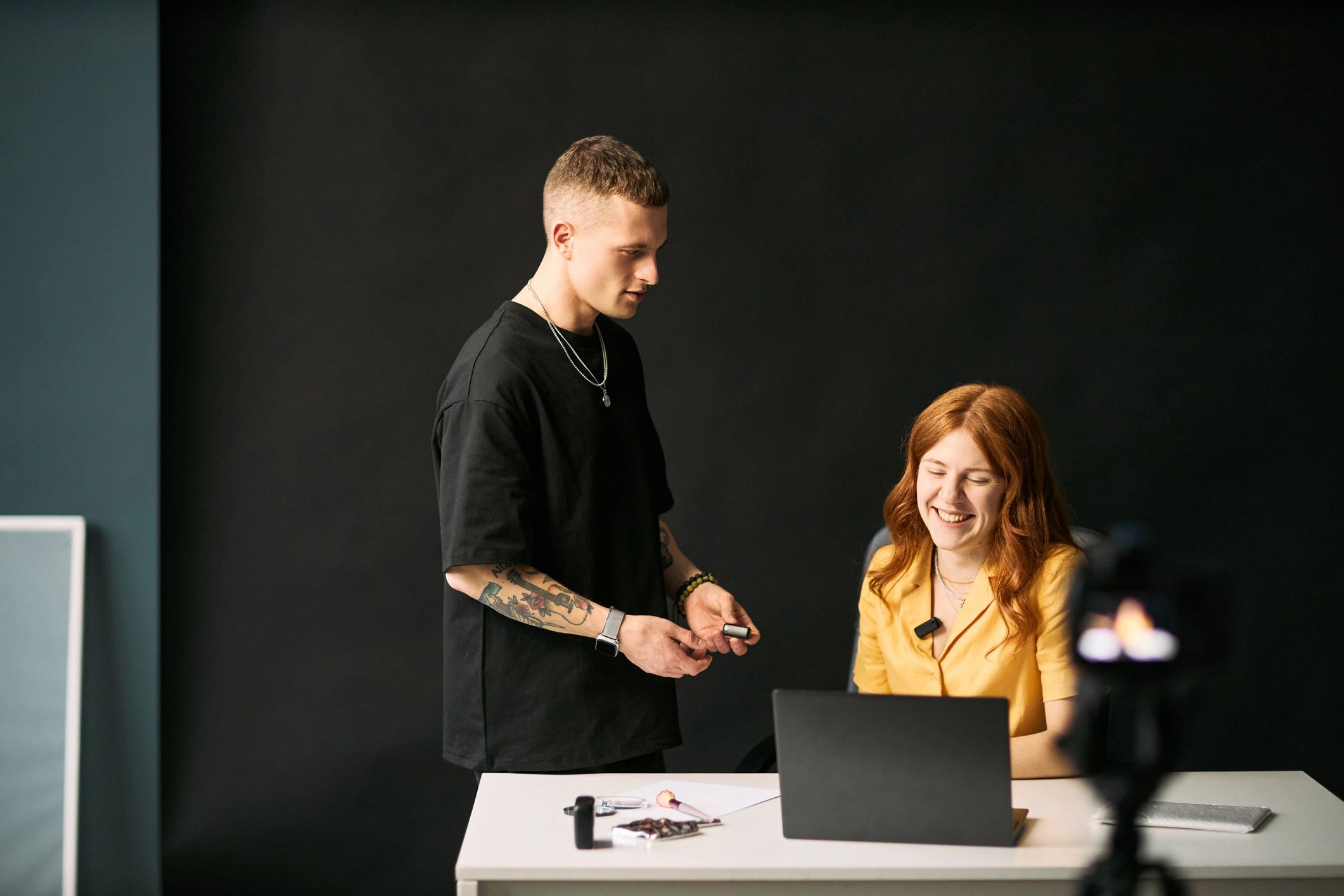 Small creative team collaborating around a laptop